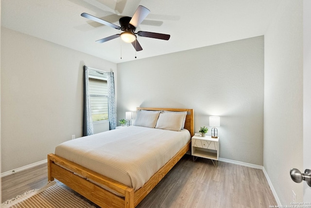 bedroom with ceiling fan and wood-type flooring