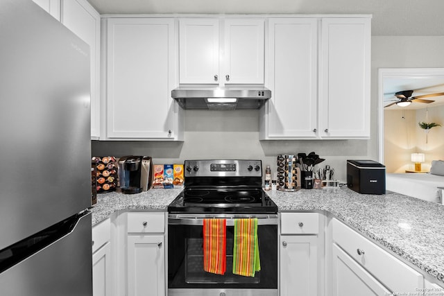 kitchen with stainless steel appliances, extractor fan, and white cabinetry