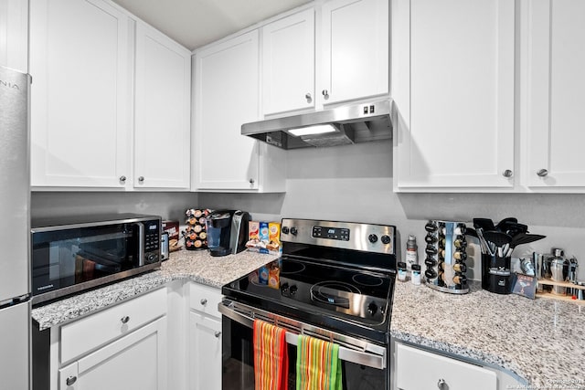 kitchen with white cabinets, light stone counters, and appliances with stainless steel finishes