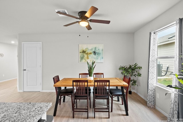 dining space featuring light wood-type flooring, ceiling fan, and a healthy amount of sunlight