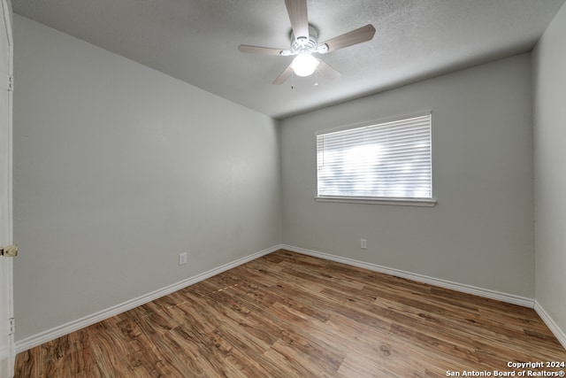 empty room featuring ceiling fan and hardwood / wood-style flooring