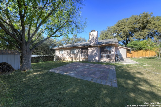 rear view of house featuring a yard and a patio