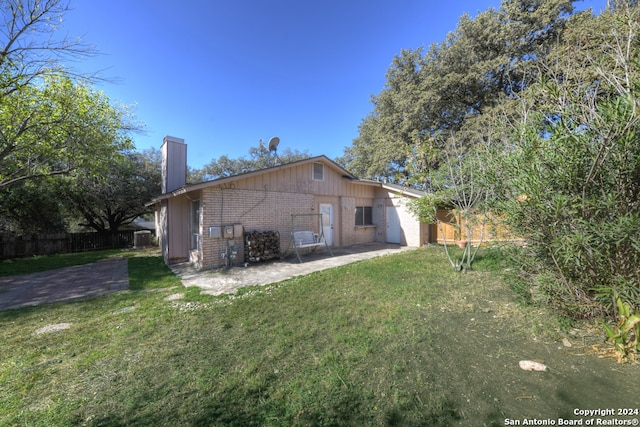 view of home's exterior with a yard and a patio area