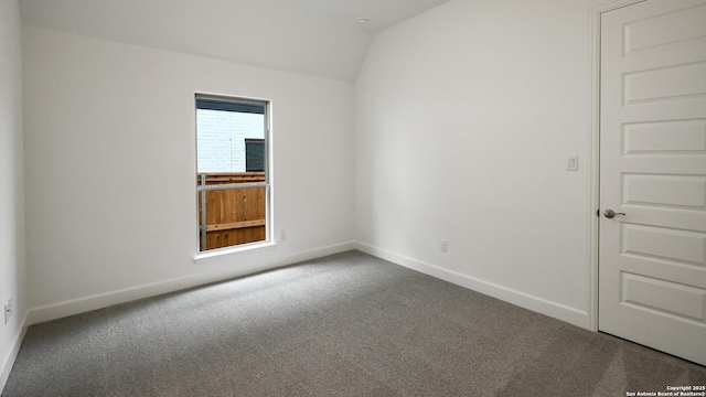 unfurnished room featuring vaulted ceiling and carpet floors