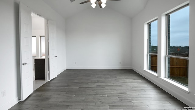 empty room featuring hardwood / wood-style floors, vaulted ceiling, and ceiling fan