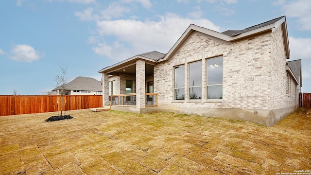 rear view of property with a lawn