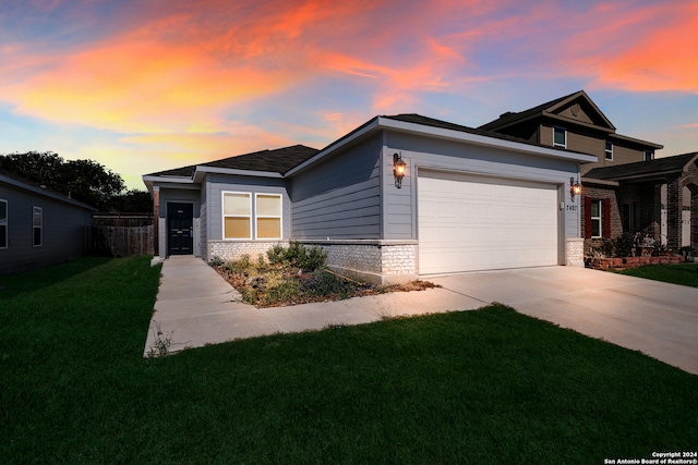 view of front of house featuring a lawn and a garage