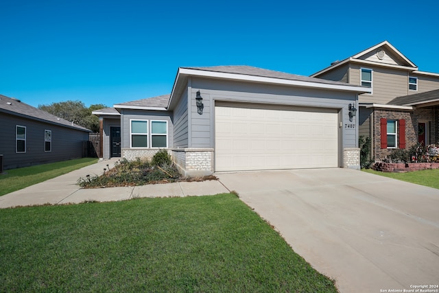 view of front of home with a front yard and a garage