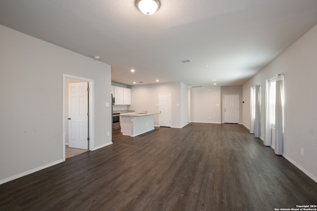 unfurnished living room with dark hardwood / wood-style flooring