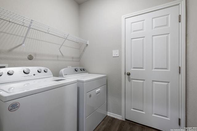 washroom featuring separate washer and dryer and dark hardwood / wood-style floors