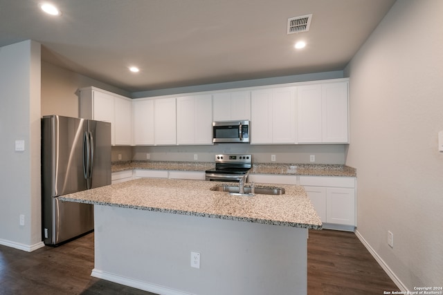 kitchen with white cabinetry, a center island with sink, and appliances with stainless steel finishes