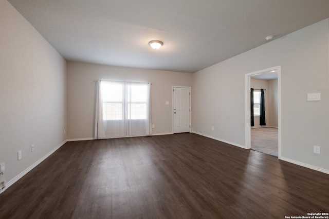 spare room with dark wood-type flooring