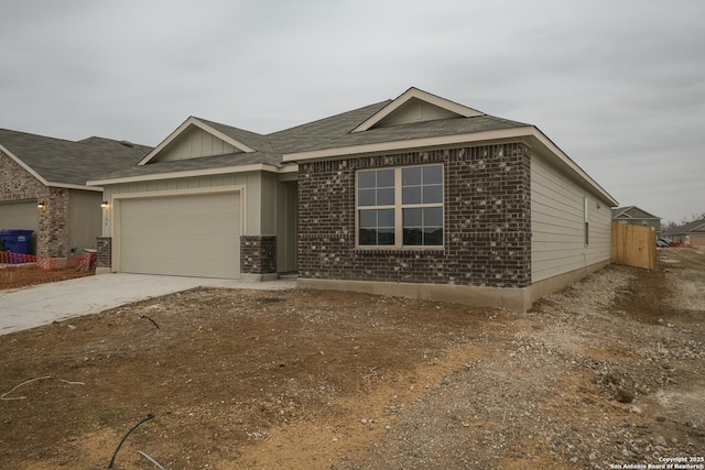 ranch-style home featuring brick siding, an attached garage, and concrete driveway