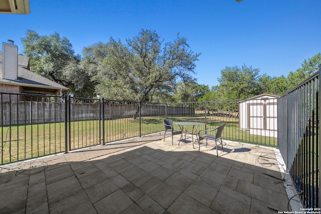 view of patio with a storage unit