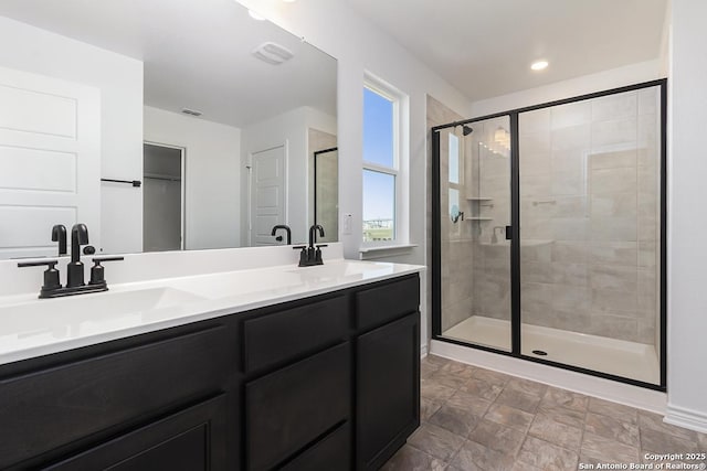 bathroom featuring vanity and an enclosed shower