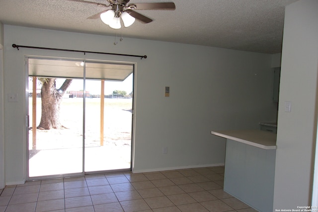 interior space featuring ceiling fan and a textured ceiling