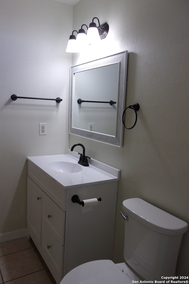 bathroom featuring tile patterned floors, vanity, and toilet