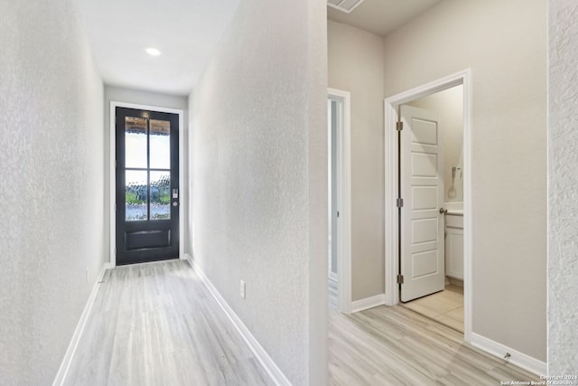 hallway with light hardwood / wood-style flooring