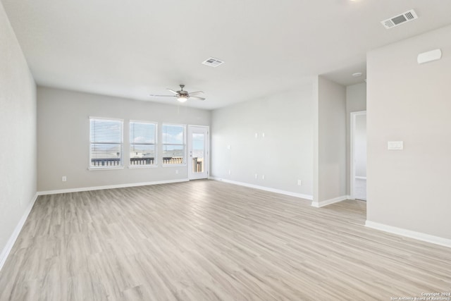 spare room with ceiling fan and light wood-type flooring