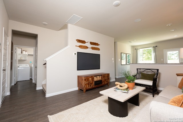 living room with washer / clothes dryer and dark hardwood / wood-style flooring