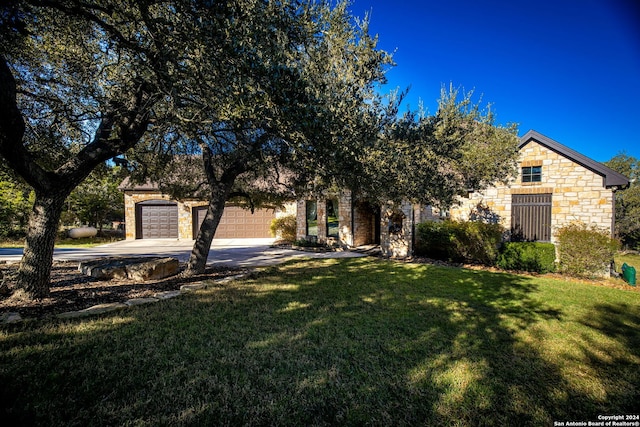 obstructed view of property with a garage and a front yard