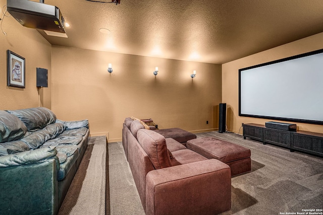 carpeted cinema room featuring a textured ceiling