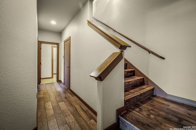 stairway with hardwood / wood-style floors