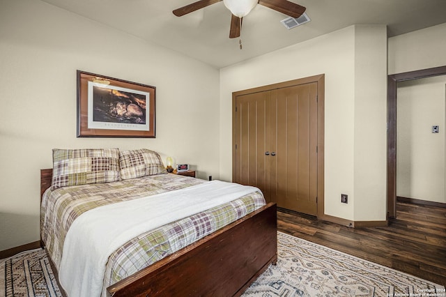 bedroom with a closet, ceiling fan, and dark hardwood / wood-style flooring