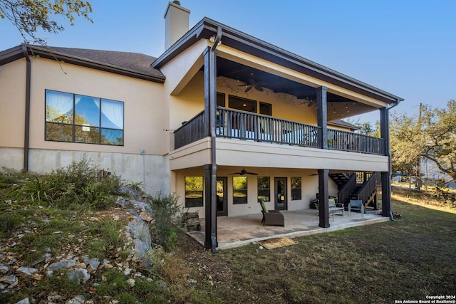 back of house featuring a yard, a patio, a balcony, and ceiling fan