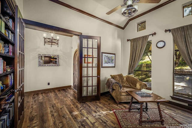 sitting room with french doors, dark hardwood / wood-style flooring, lofted ceiling, ceiling fan with notable chandelier, and ornamental molding