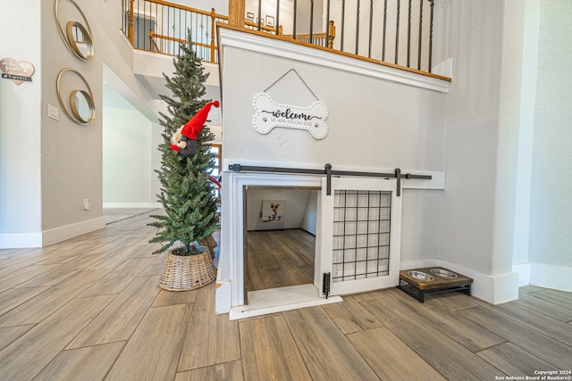 interior details with a barn door and wood-type flooring