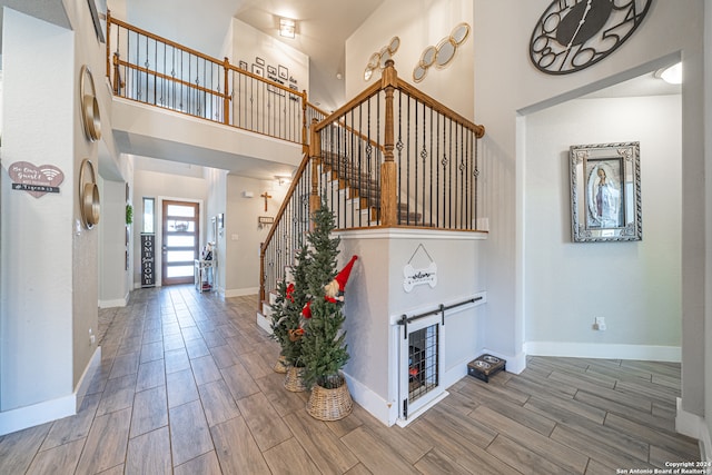 entrance foyer with hardwood / wood-style flooring and a high ceiling