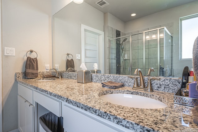 bathroom with vanity and an enclosed shower