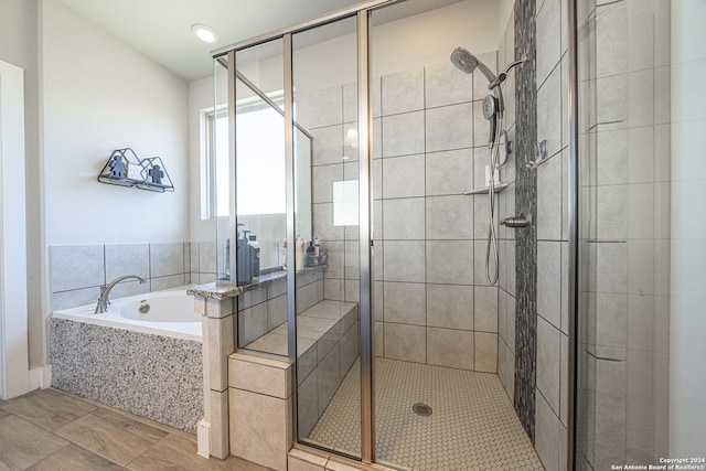 bathroom featuring independent shower and bath