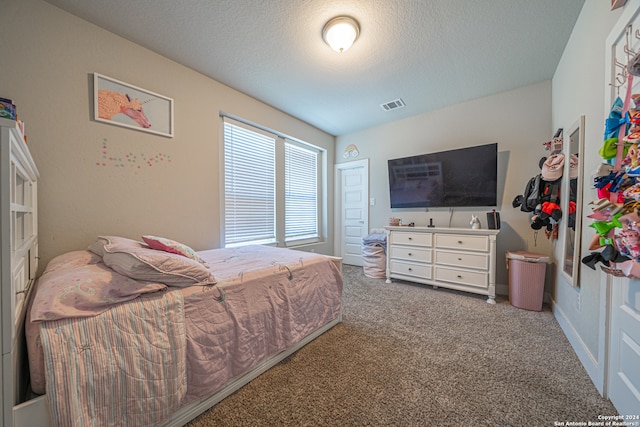 bedroom featuring a textured ceiling and carpet floors