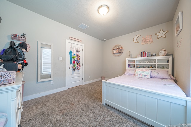 bedroom with light carpet and a textured ceiling