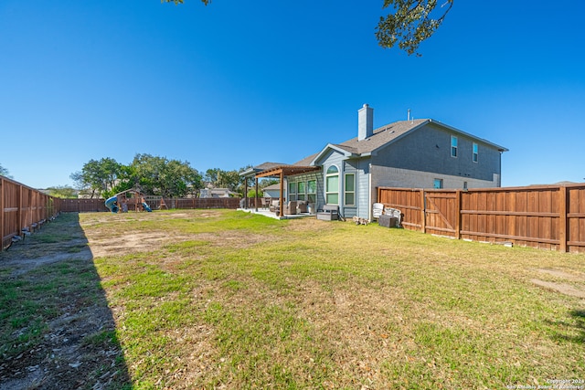 view of yard featuring a playground and a pergola