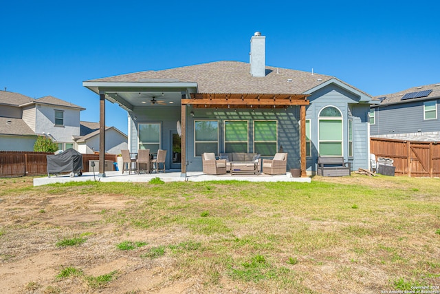 rear view of house with an outdoor hangout area, a patio, ceiling fan, and a lawn