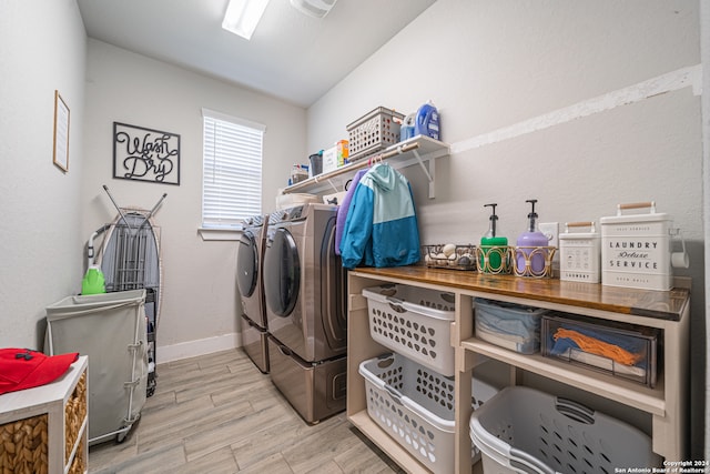 clothes washing area with light hardwood / wood-style floors and washing machine and dryer