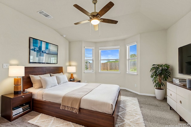 carpeted bedroom with ceiling fan and vaulted ceiling