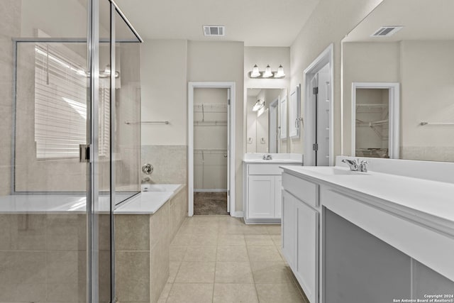 bathroom featuring tile patterned flooring, vanity, and independent shower and bath