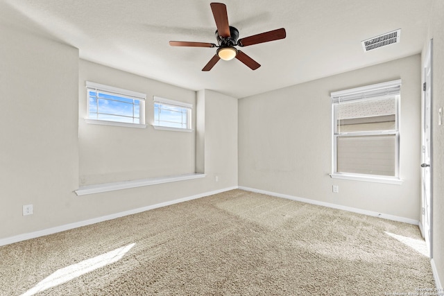 unfurnished room featuring ceiling fan and carpet floors