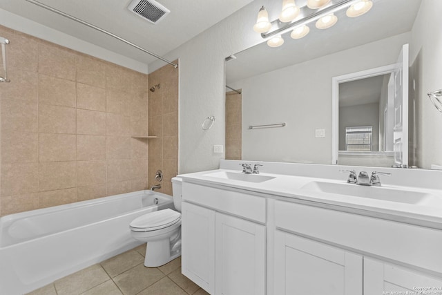 full bathroom featuring toilet, vanity, tiled shower / bath combo, and tile patterned floors