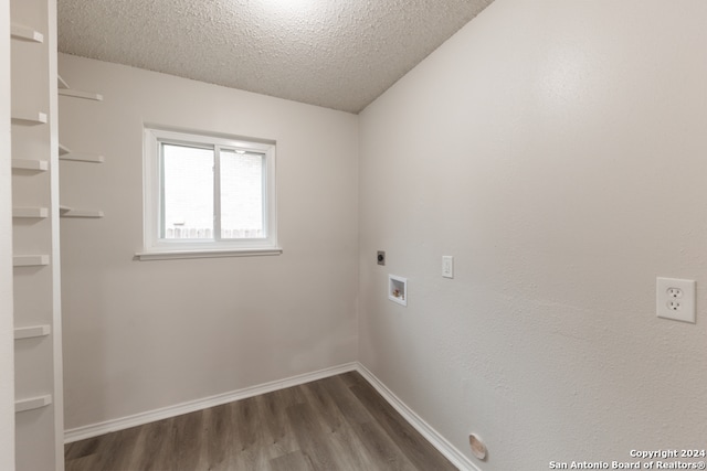 clothes washing area featuring washer hookup, electric dryer hookup, dark hardwood / wood-style flooring, and a textured ceiling