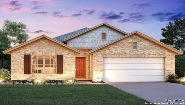 view of front of house with brick siding, a lawn, driveway, and an attached garage