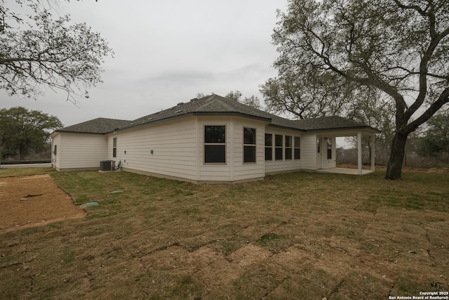 rear view of house featuring a patio area, a lawn, and cooling unit