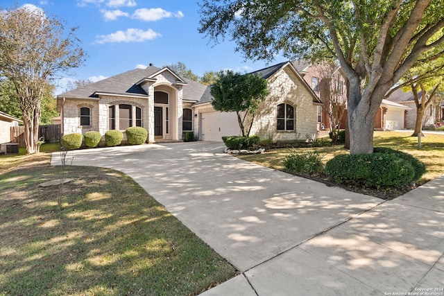 view of front of property featuring a front lawn and a garage