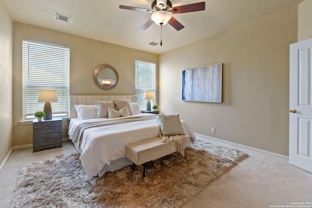 bedroom with ceiling fan and light colored carpet