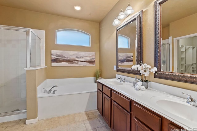 bathroom featuring tile patterned flooring, vanity, a healthy amount of sunlight, and plus walk in shower