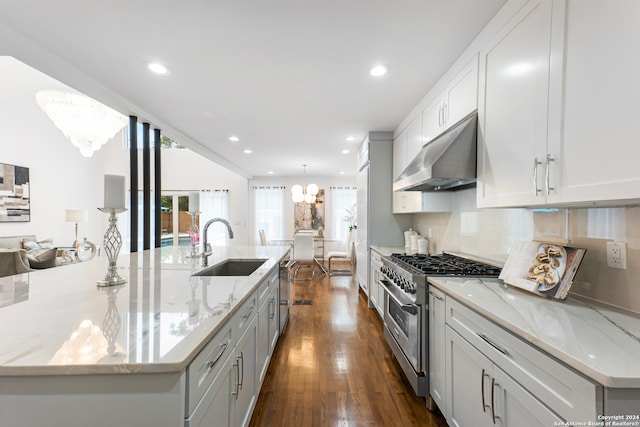 kitchen featuring stainless steel appliances, dark hardwood / wood-style flooring, range hood, a large island with sink, and a chandelier